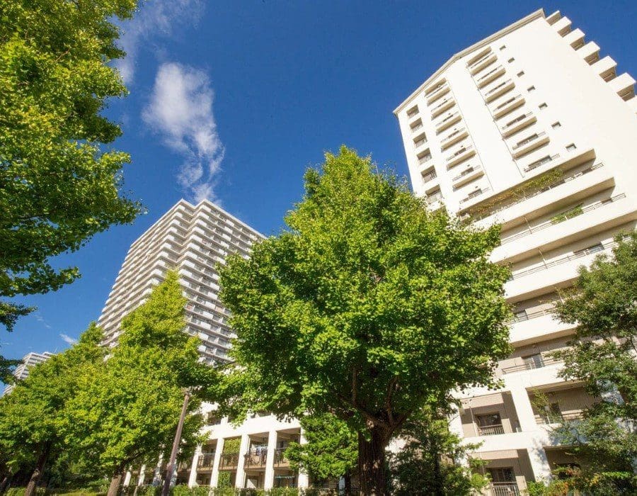 A view of some buildings and trees from below.