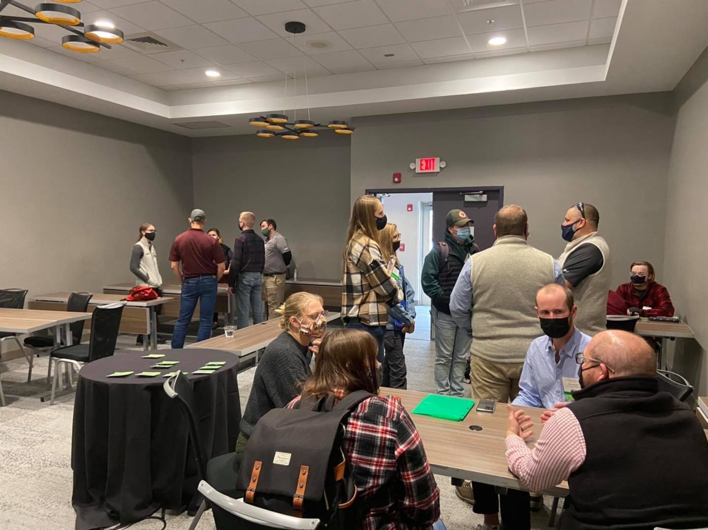 People in a meeting room wearing masks.