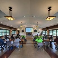 People gathered in a large room for a presentation.