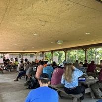 A group of people gathered in a pavilion.