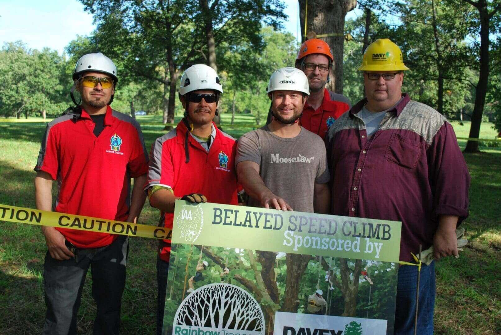 Men in hard hats at a speed climb event.