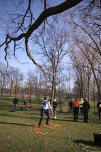 A woman competes in an outdoor obstacle course.