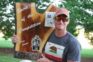 Man holding a "Spirit of the Competition" trophy.