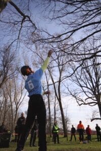 Man throwing a frisbee in a park.