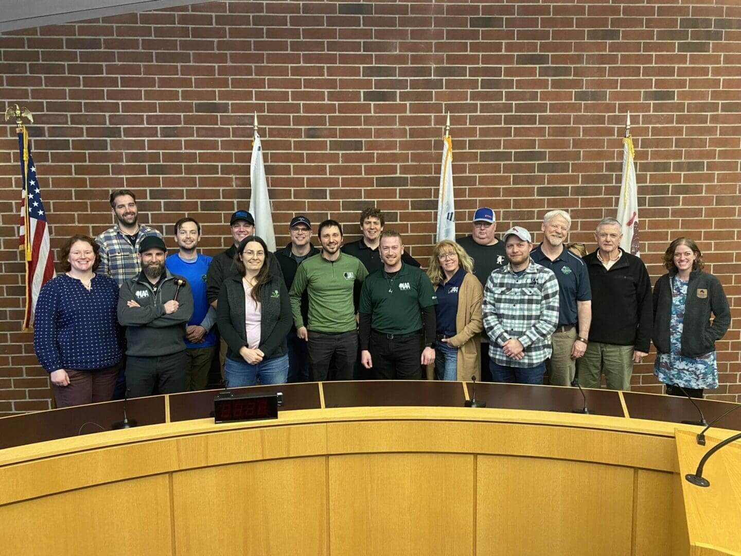 Board members posing behind council dais