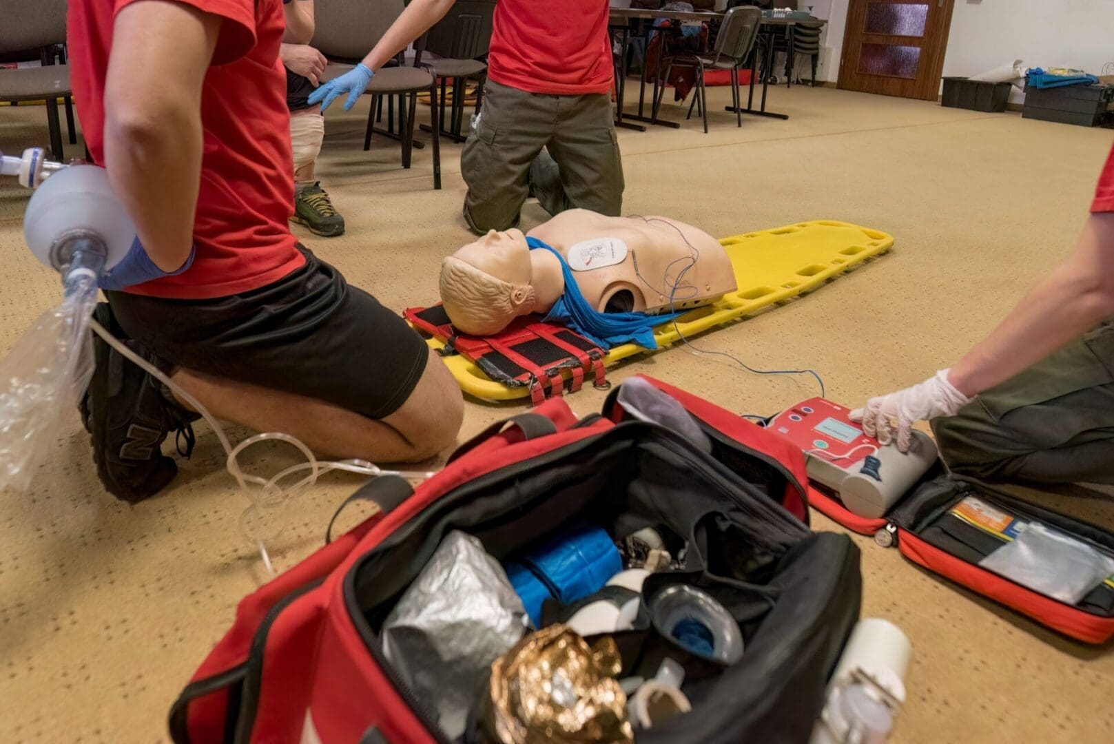 CPR training with AED and mannequin.