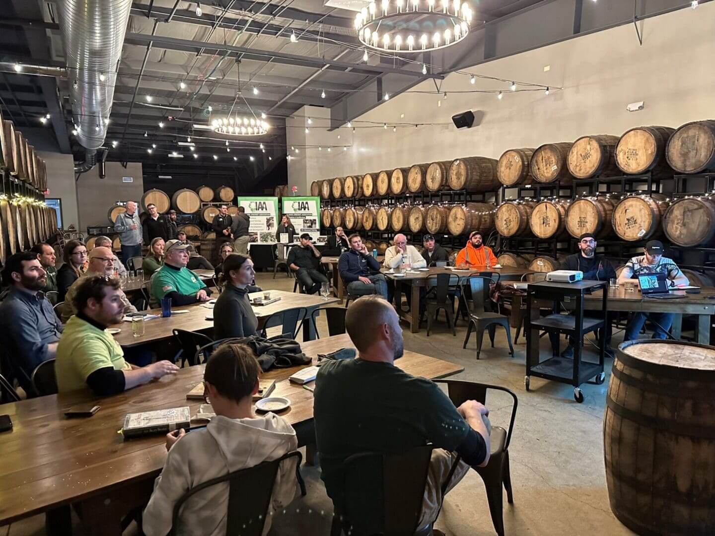 People attending a presentation in a brewery.