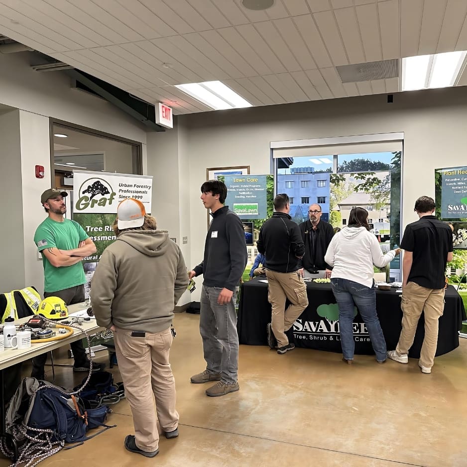 Indoor event with informational booths and attendees.