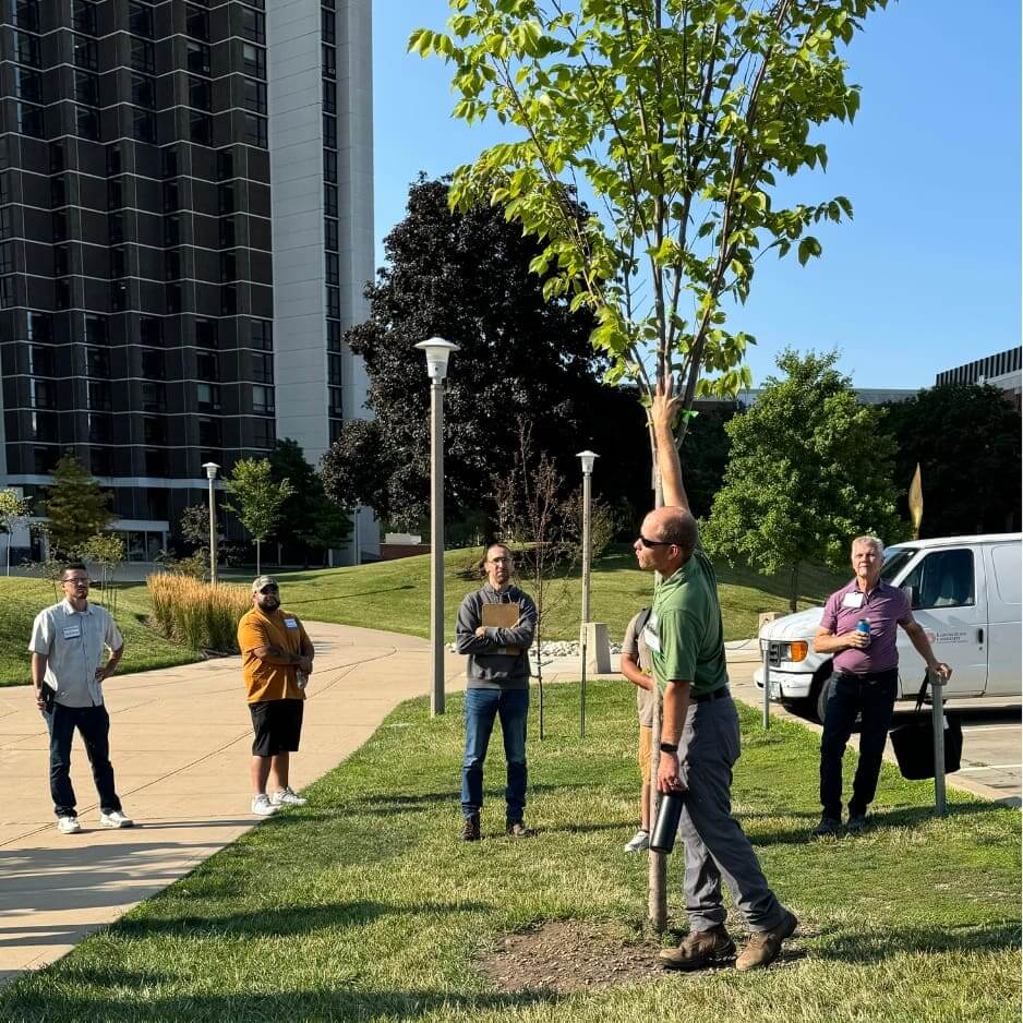 Group learning about trees in a park.
