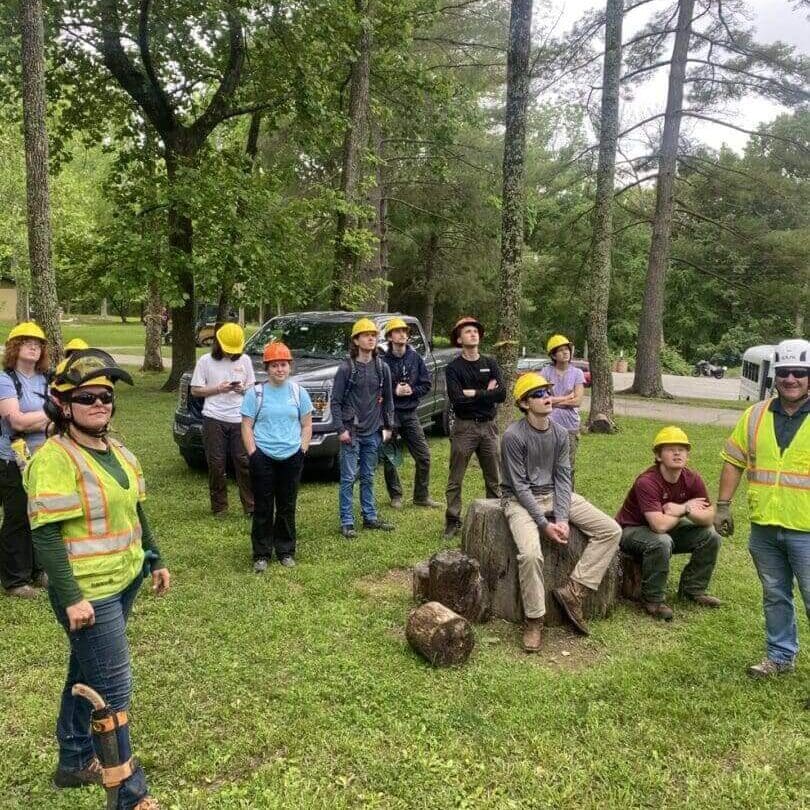 Group of people wearing hard hats outdoors
